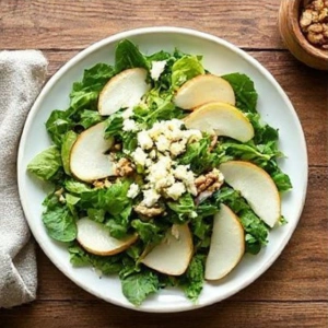 pear slices and crumbled gorgonzola cheese evenly across the salad