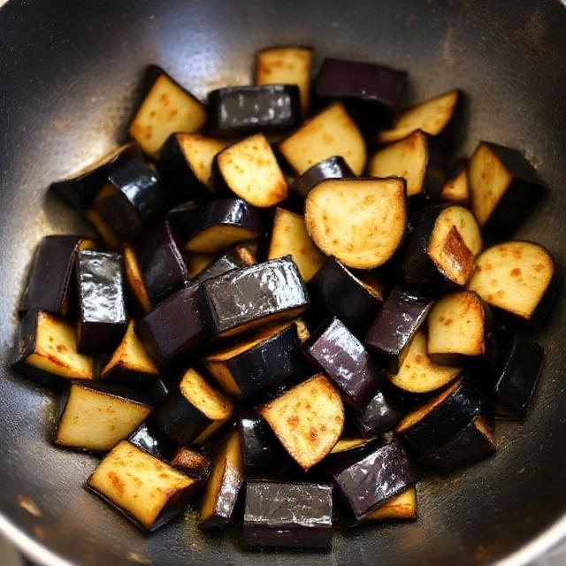 Add eggplant pieces and stir-fry 